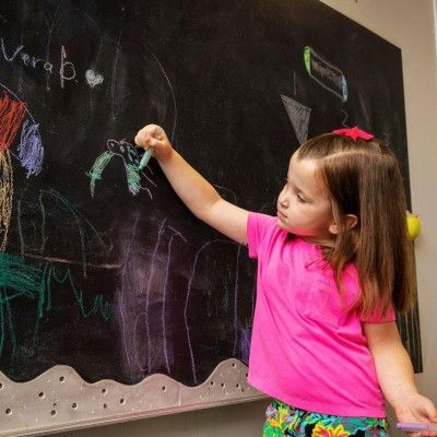 Lila Drawing on Chalkboard