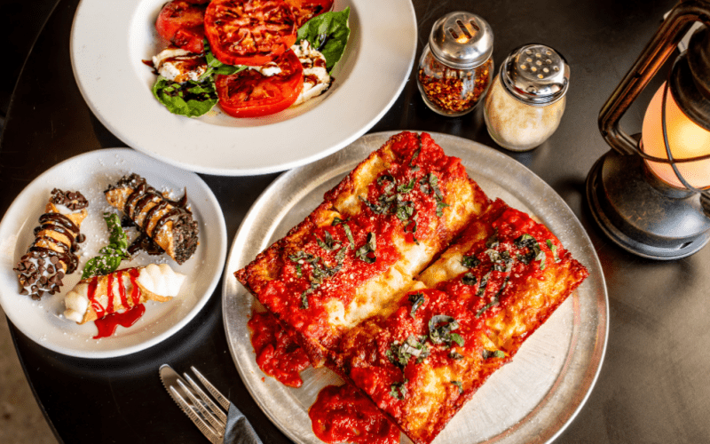 image of Rossville Pizza spread, Including caprese salad, Pizza, and cannolis